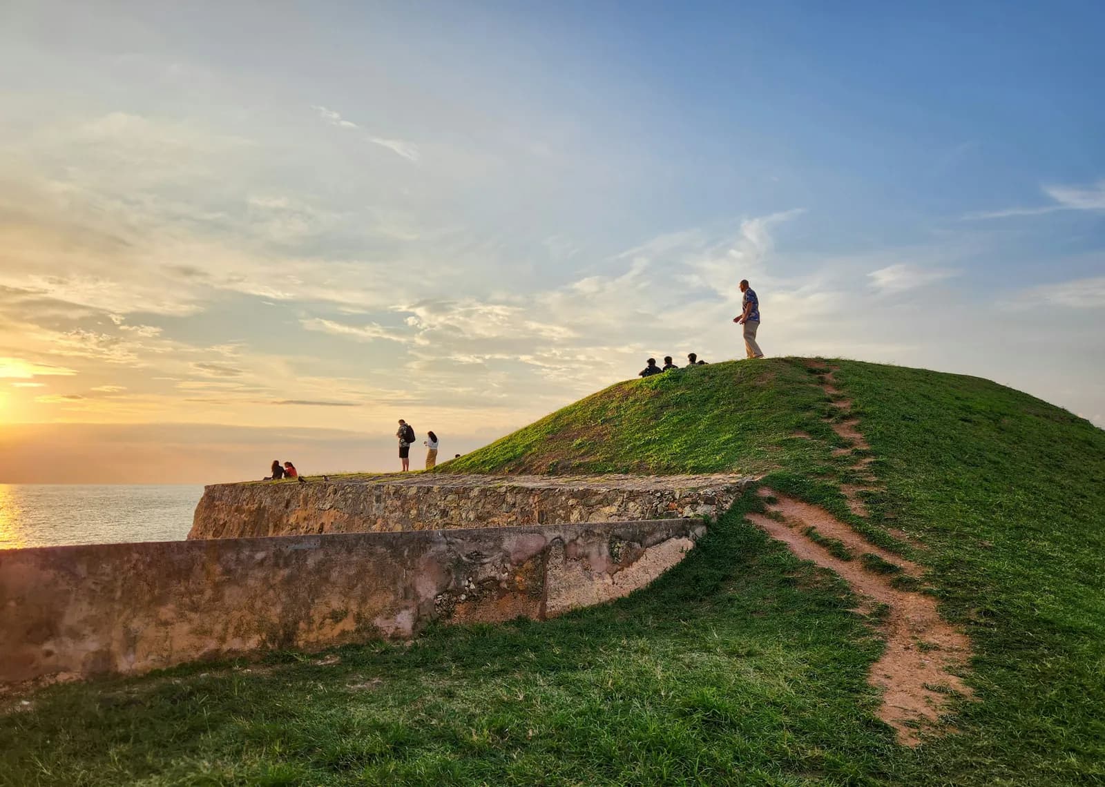 Sunset over the grass ramparts of Galle Fort on Sri Lanka's south coast
