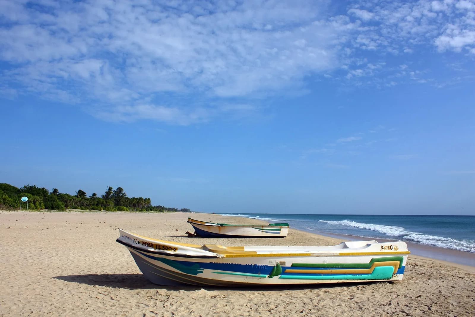 Nilaveli Beach coastline with calm blue waters and coconut palms