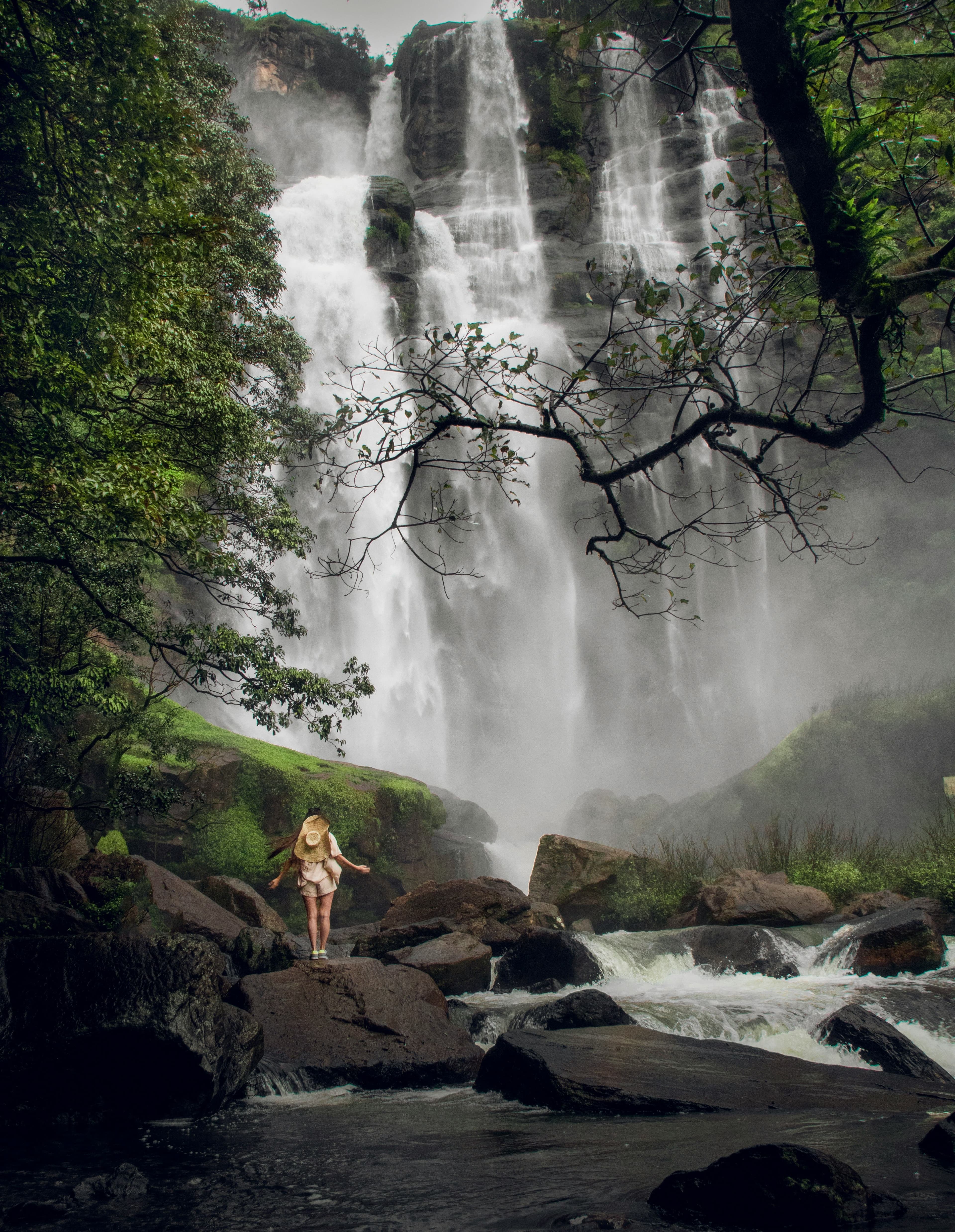 Pristine mountain waterfall plunging into a natural freshwater pool in Sri Lanka hills.