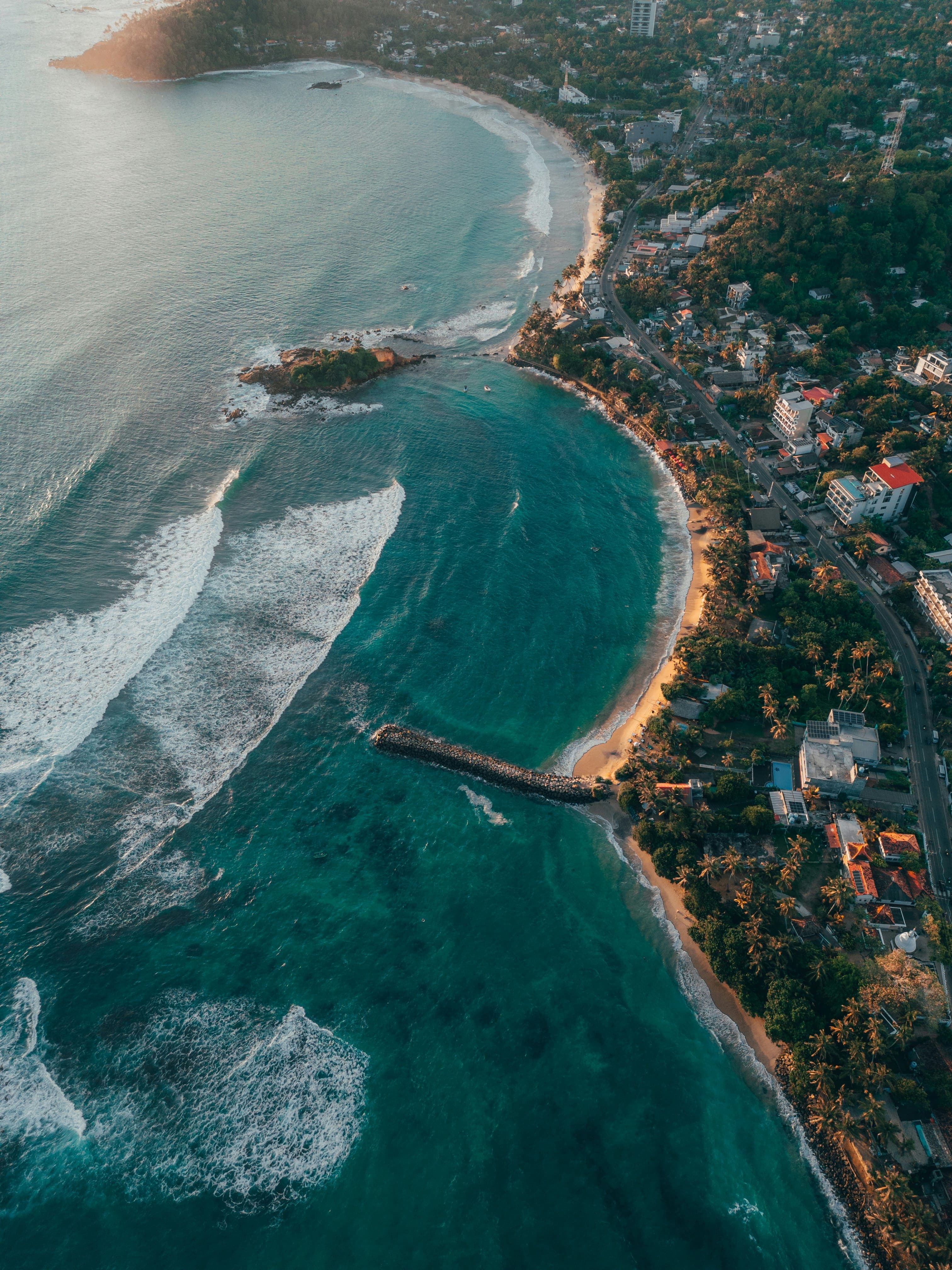Pristine tropical beach shoreline with turquoise waves in southern Sri Lanka.
