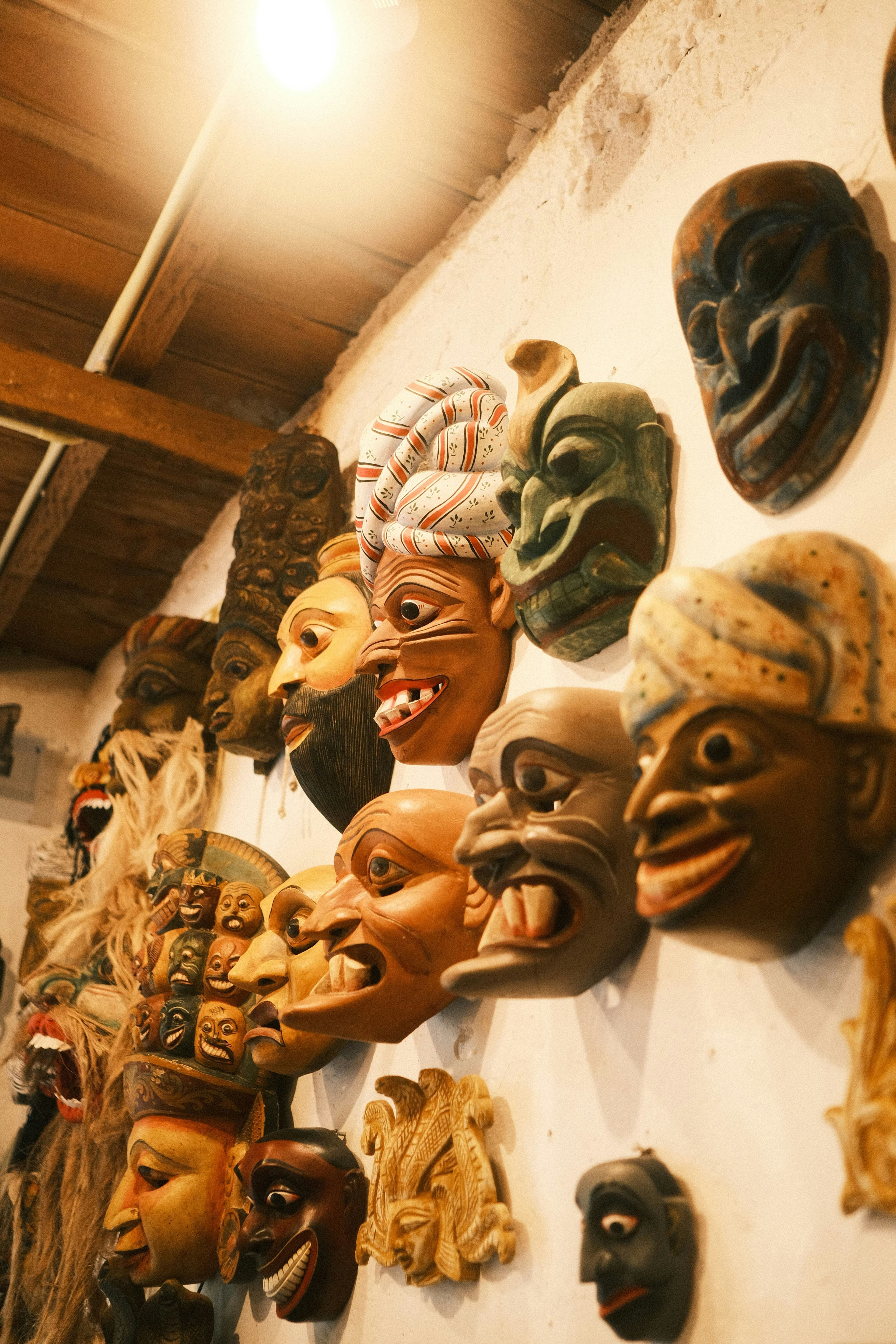 Intricate folk art mask featuring vibrant colors and traditional protective symbols.