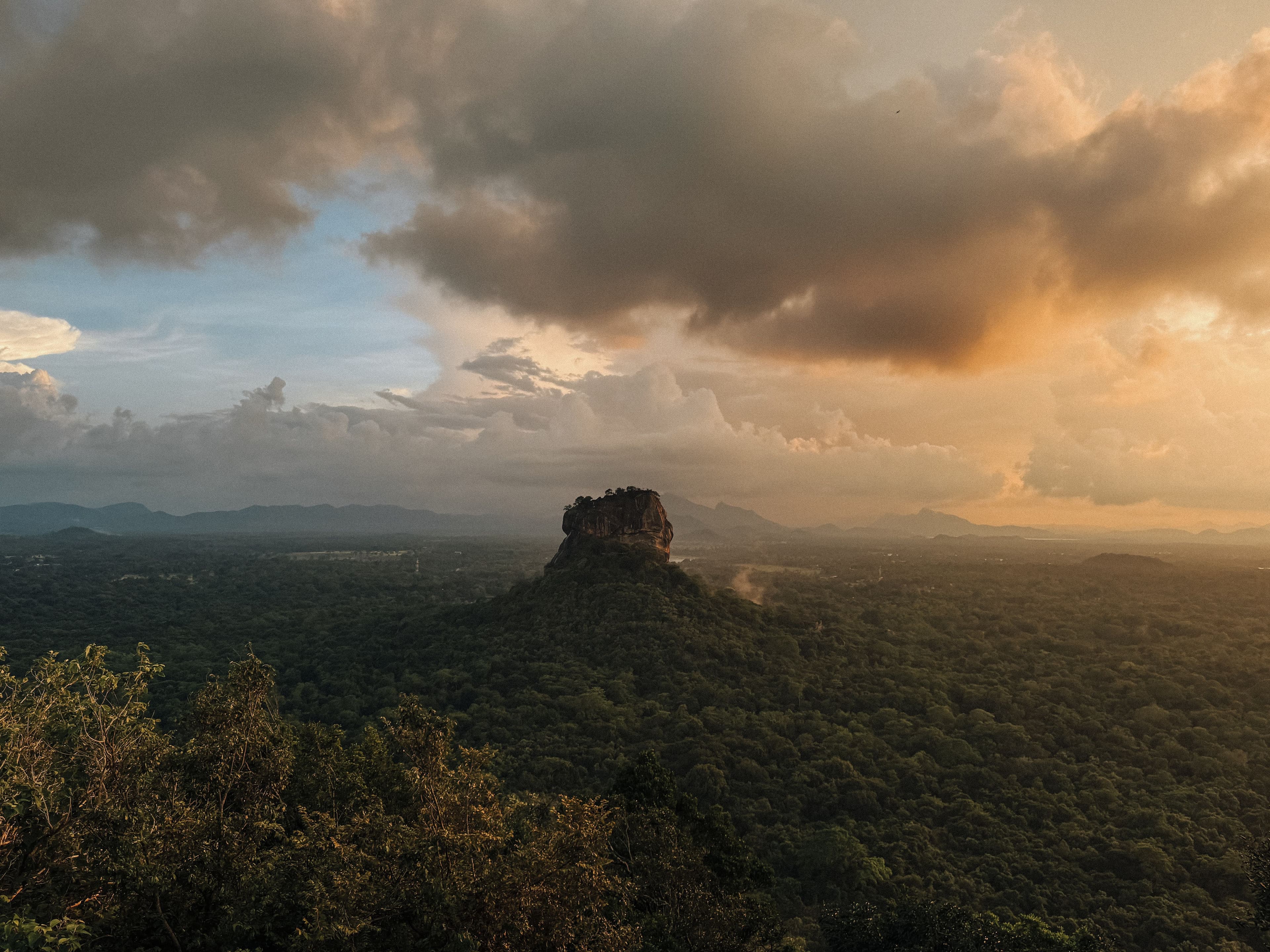 Dramatic wide angle of the UNESCO World Heritage Sigiriya Rock rising from jungle.