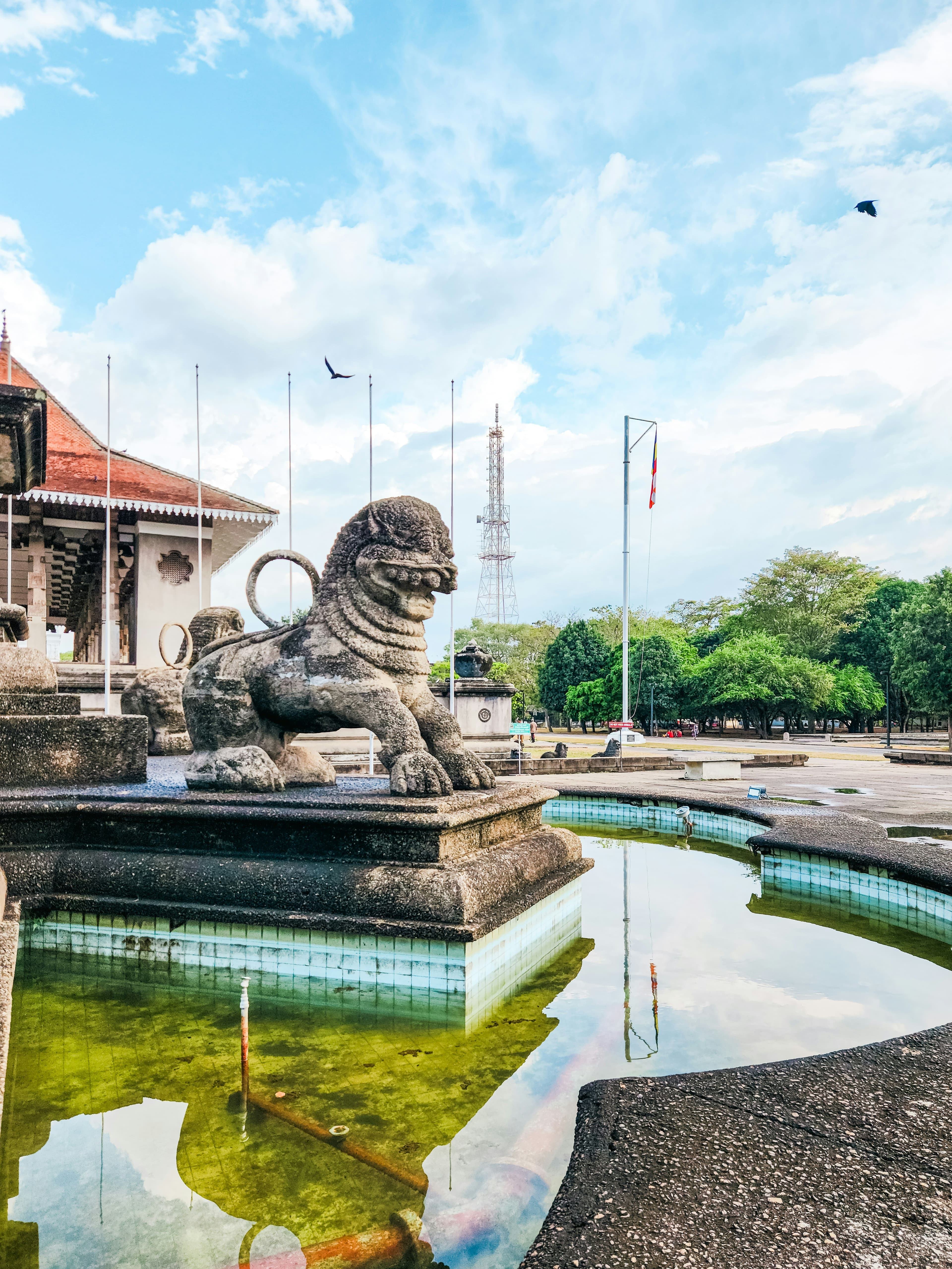 Serene cultural shrine decorated with vibrant tropical flower offerings.