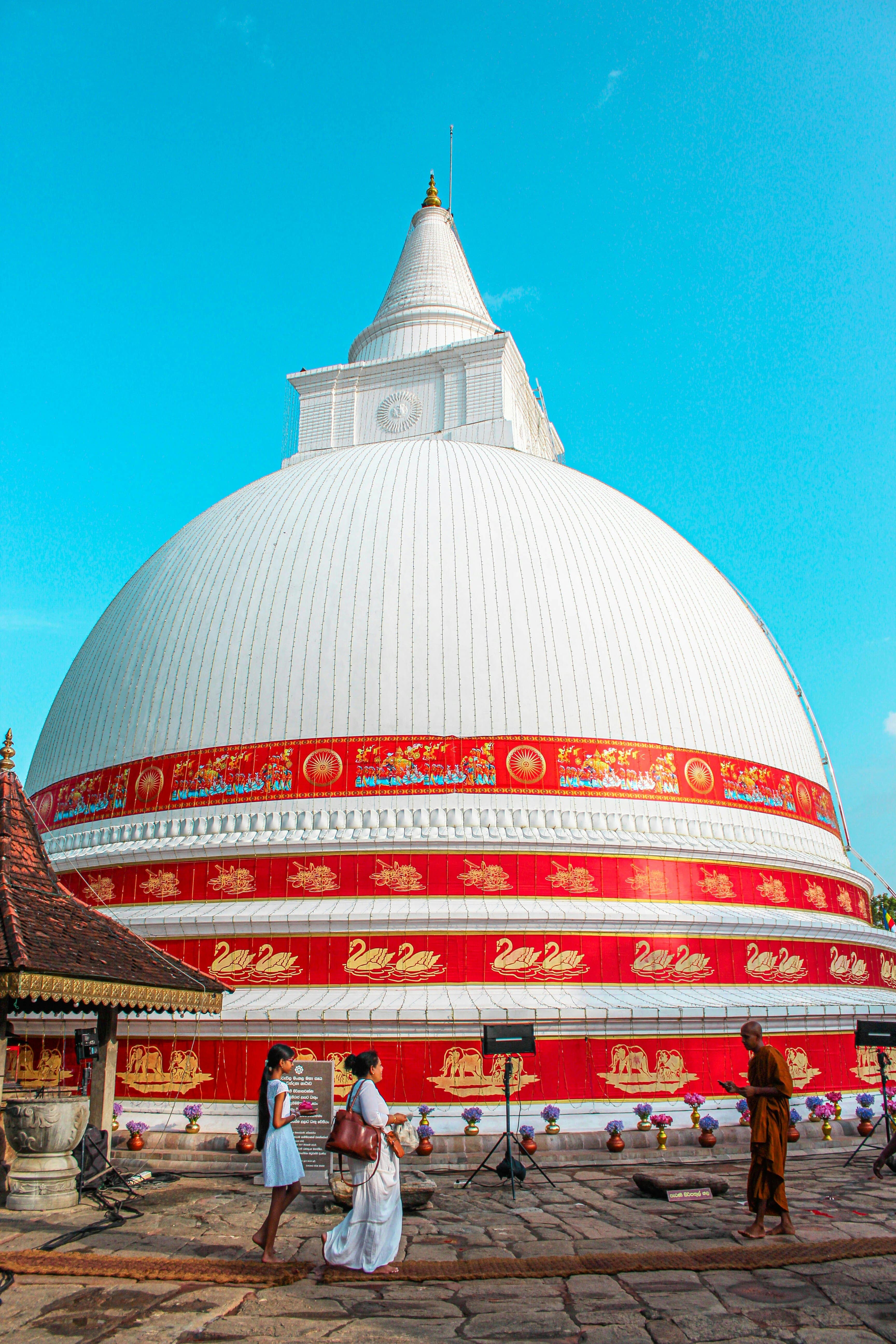Ancient Buddhist temple complex surrounded by sacred greenery and peaceful grounds.