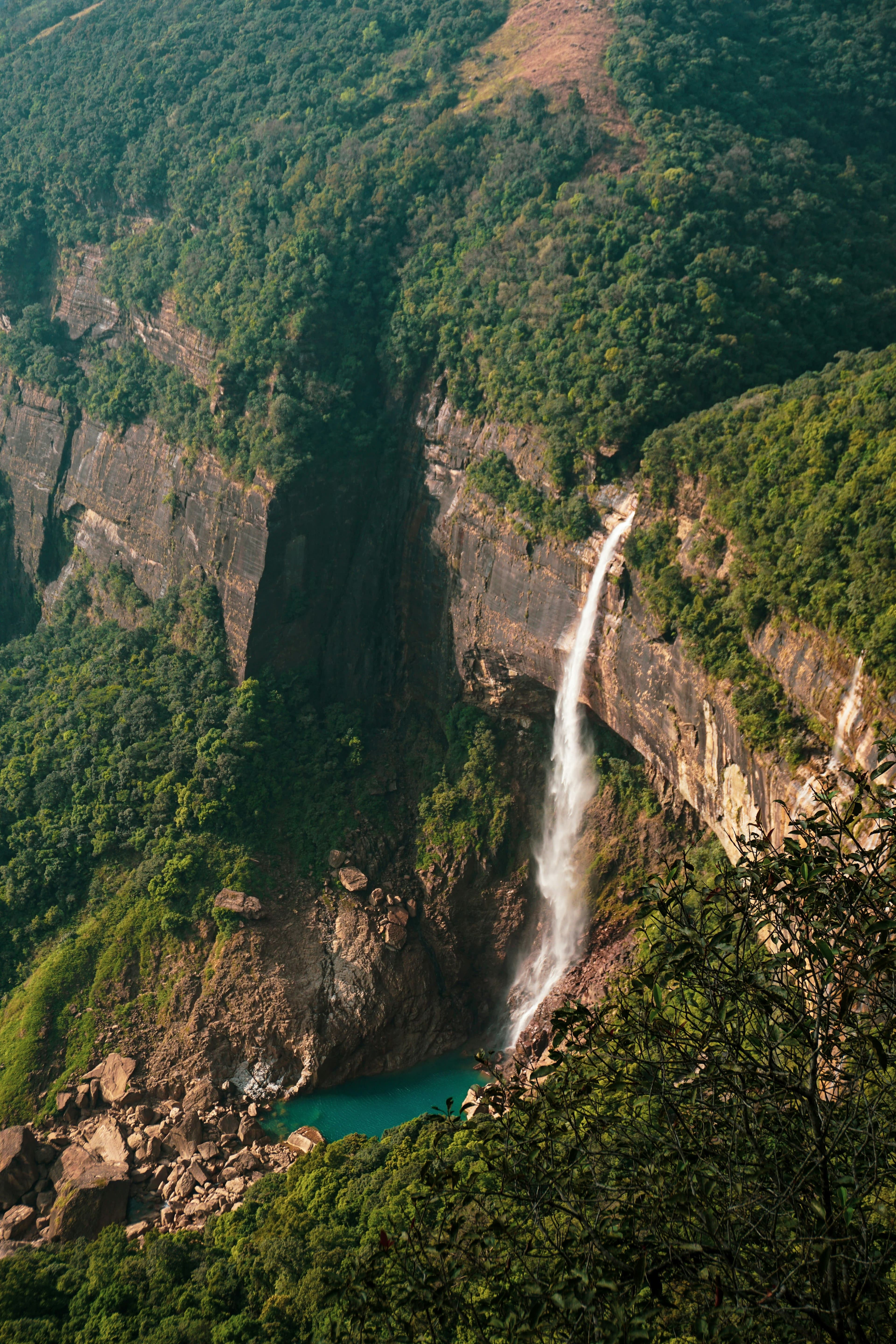 Spectacular tall waterfall tumbling down steep rock face in central highlands.