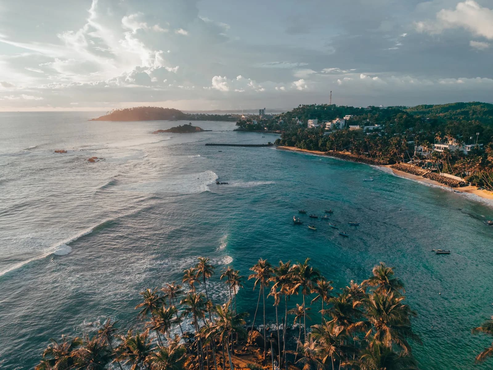 Bentota Beach wide golden sand coastline with luxury resort and palm trees, Sri Lanka